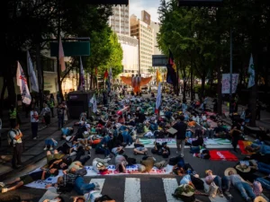 People lie on a street during a protest.