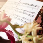 Elegant Sheet Music On Stand Through Flowers